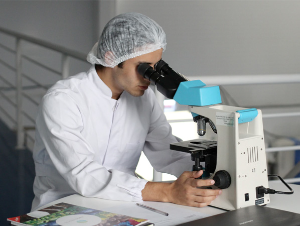 An image of a scientist using a microscope.
